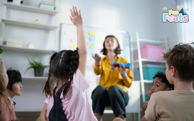 little girl raising her hand in class