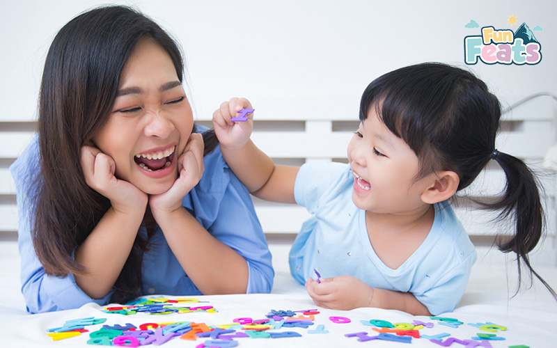 Child playing with alphabet toys in a sensory-friendly space for autism support.